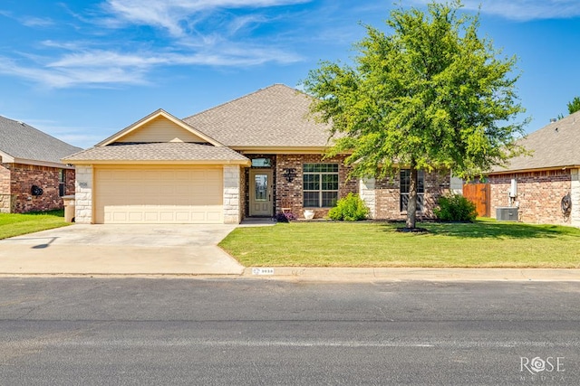 3926 Caroline Ln, San Angelo, TX 76904 - view of front facade with an attached garage, concrete driveway, a shingled roof, a front yard, and brick siding