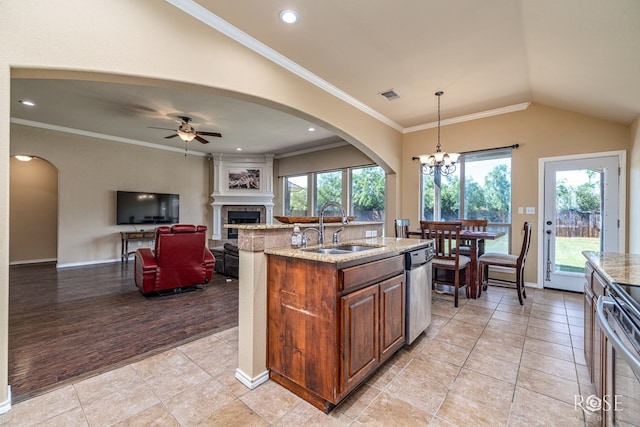 3926 Caroline Ln, San Angelo, TX 76904 - kitchen featuring stainless steel appliances, a fireplace, light stone countertops, a chandelier, and a ceiling fan