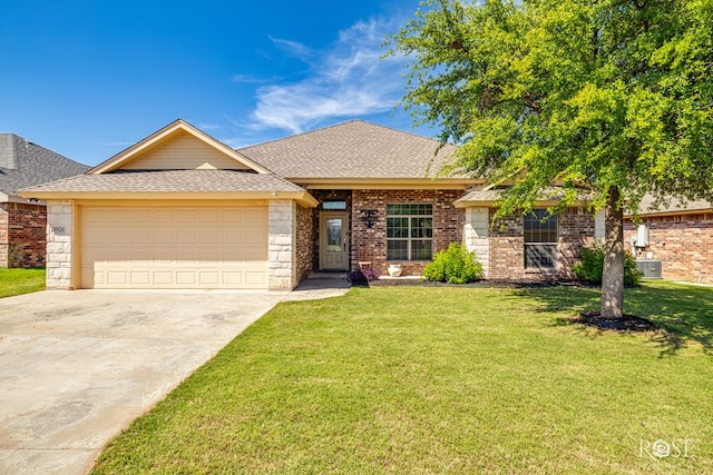 3926 Caroline Ln, San Angelo, TX 76904 - view of front of home with a shingled roof, an attached garage, a front yard, concrete driveway, and brick siding