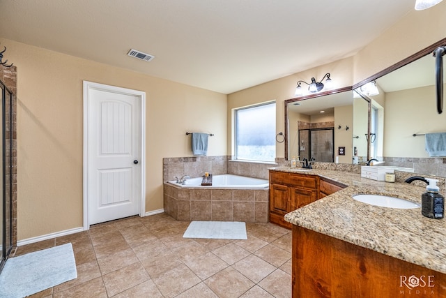 3926 Caroline Ln, San Angelo, TX 76904 - bathroom featuring a shower stall, a bath, vanity, and tile patterned floors