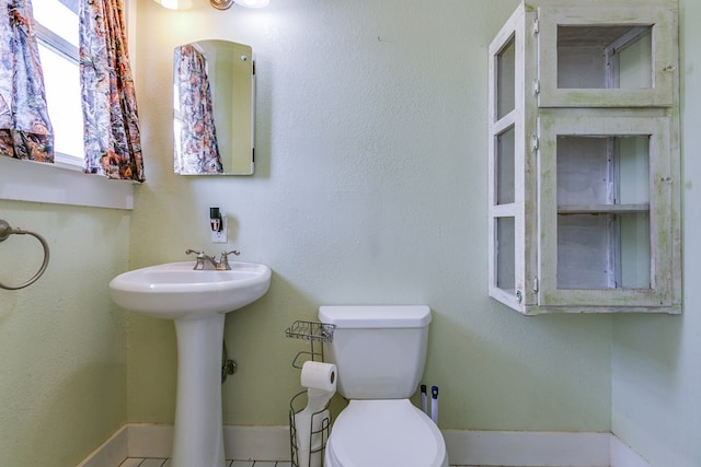3805 Ogden St, San Angelo, TX 76903 - bathroom with toilet, baseboards, and a sink
