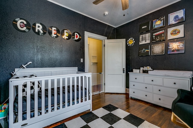 3805 Ogden St, San Angelo, TX 76903 - bedroom with wood finished floors, a textured wall, and ornamental molding