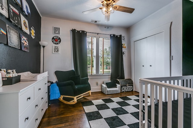 3805 Ogden St, San Angelo, TX 76903 - bedroom featuring dark wood-style flooring, a closet, ceiling fan, and a crib