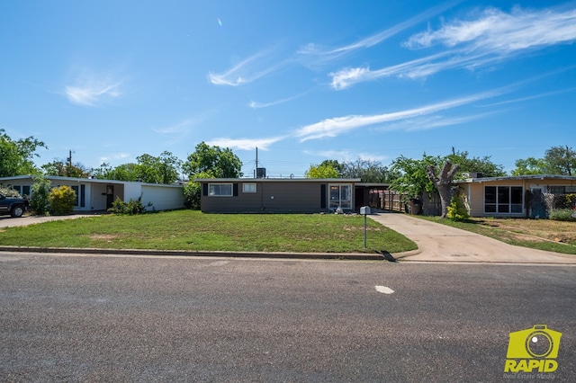 2123 Wilson St, San Angelo, TX 76901 - view of front of home with driveway, a front lawn, and a carport
