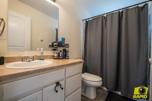 2123 Wilson St, San Angelo, TX 76901 - full bath with toilet, vanity, wood finished floors, and curtained shower