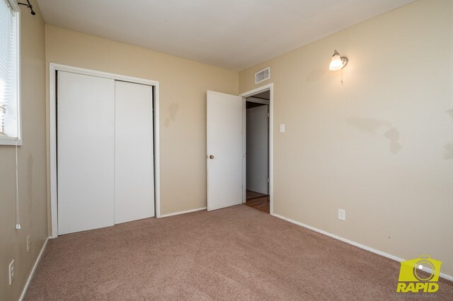 2123 Wilson St, San Angelo, TX 76901 - unfurnished bedroom with carpet flooring, a closet, and baseboards