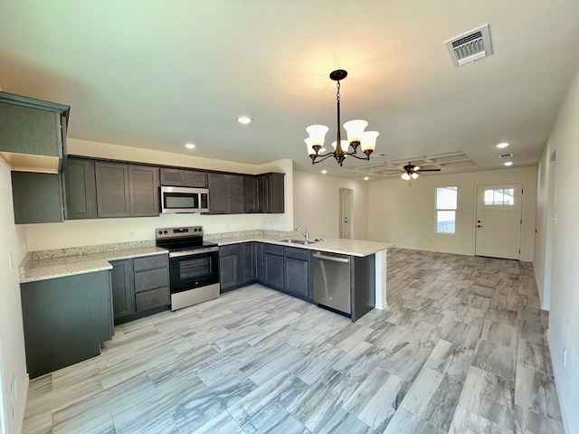 115 E 41st St, San Angelo, TX 76903 - kitchen featuring stainless steel appliances, a chandelier, a ceiling fan, open floor plan, and recessed lighting