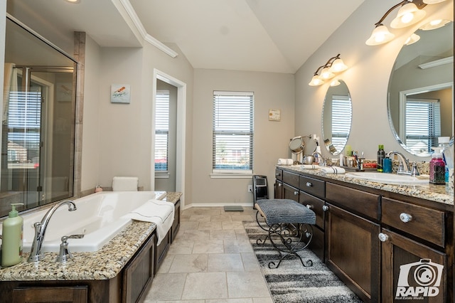 5010 Red Oak Ln, San Angelo, TX 76904 - bathroom with vanity, a bath, lofted ceiling, baseboards, and a shower with door