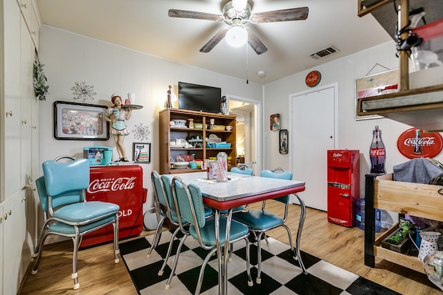 dining space with ceiling fan and light hardwood / wood-style floors