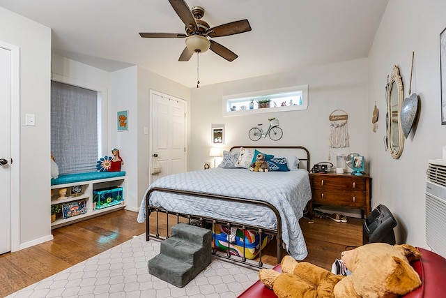 bedroom with wood-type flooring and ceiling fan