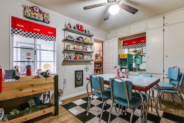 dining space featuring hardwood / wood-style flooring, ceiling fan, and crown molding