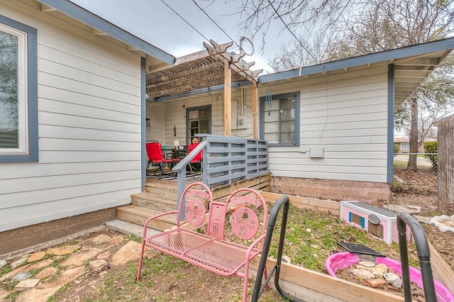 property entrance with a pergola