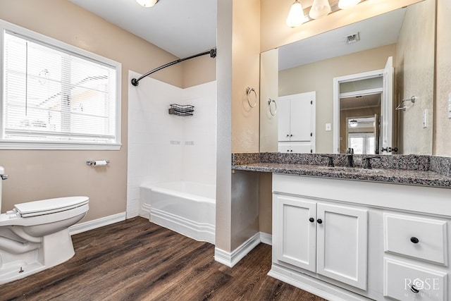 2105 Coleman St, San Angelo, TX 76901 - bathroom with vanity, wood finished floors, shower / bathtub combination, and healthy amount of natural light
