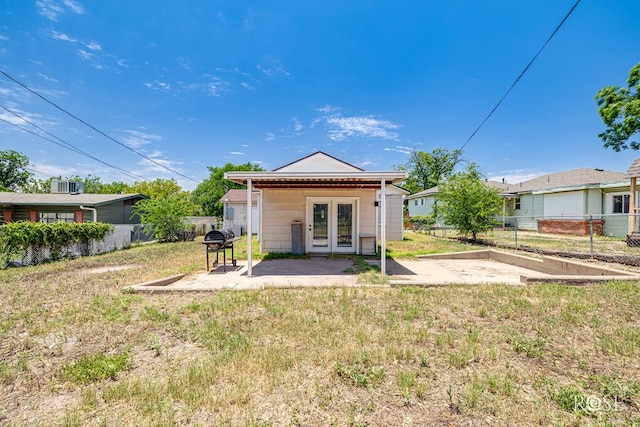 2105 Coleman St, San Angelo, TX 76901 - back of property with french doors, a patio, and a fenced backyard