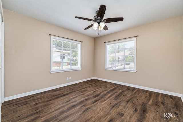 2105 Coleman St, San Angelo, TX 76901 - empty room with healthy amount of natural light, dark wood-style floors, and a ceiling fan