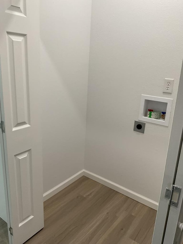 709 E Harris Ave, San Angelo, TX 76903 - laundry room featuring hookup for an electric dryer, wood finished floors, washer hookup, and baseboards