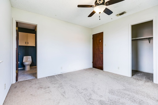 2756 Eunice Dr, San Angelo, TX 76901 - unfurnished bedroom with carpet floors, a closet, ensuite bathroom, a textured ceiling, and ceiling fan
