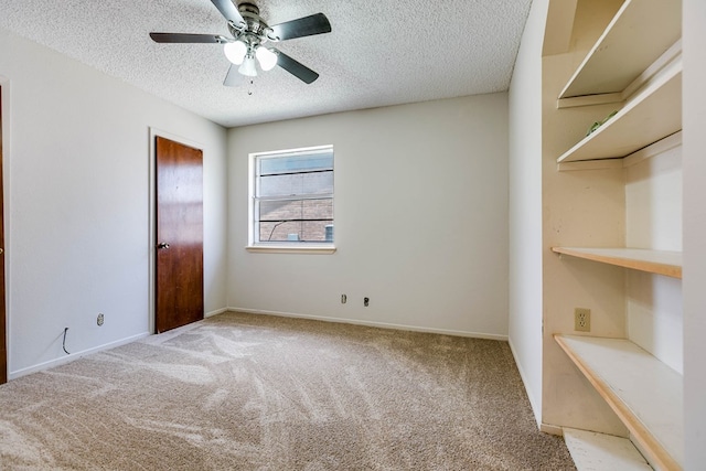 2756 Eunice Dr, San Angelo, TX 76901 - unfurnished bedroom with carpet floors, a textured ceiling, and a ceiling fan