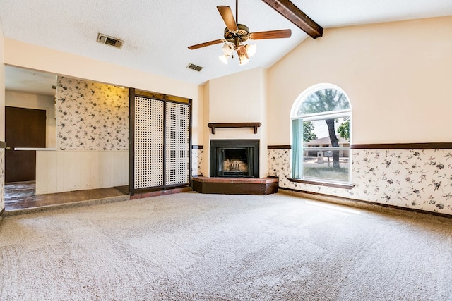 2756 Eunice Dr, San Angelo, TX 76901 - unfurnished living room featuring a wainscoted wall, carpet floors, wallpapered walls, a fireplace with raised hearth, and ceiling fan