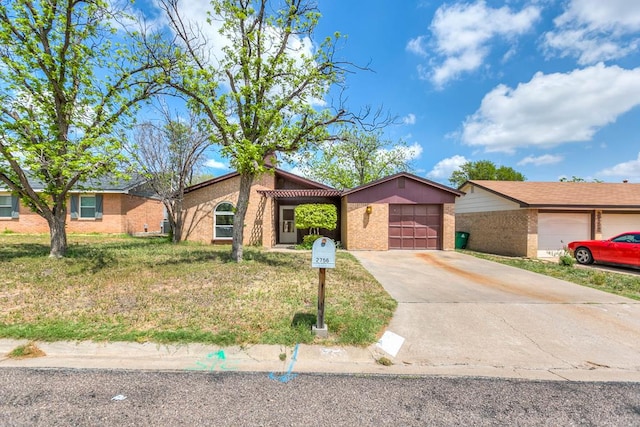2756 Eunice Dr, San Angelo, TX 76901 - view of front of home with brick siding, an attached garage, and driveway