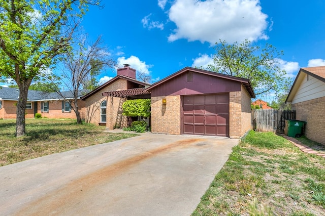 2756 Eunice Dr, San Angelo, TX 76901 - view of front of home with brick siding, concrete driveway, a chimney, and a garage