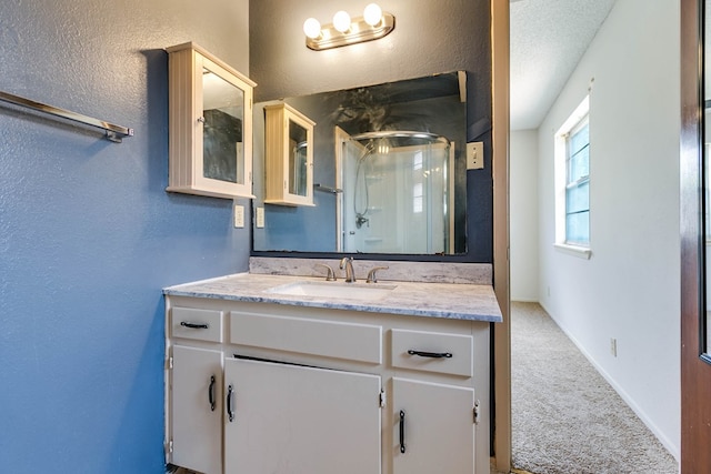 2756 Eunice Dr, San Angelo, TX 76901 - full bath with a stall shower, vanity, and a textured wall