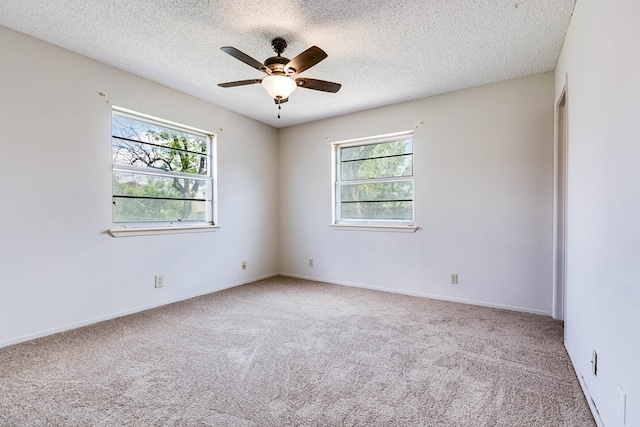 2756 Eunice Dr, San Angelo, TX 76901 - carpeted empty room featuring healthy amount of natural light, ceiling fan, and a textured ceiling