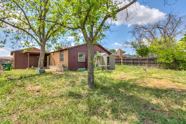 2756 Eunice Dr, San Angelo, TX 76901 - rear view of house with a fenced backyard and a storage shed