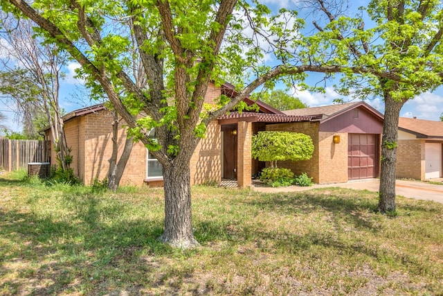 2756 Eunice Dr, San Angelo, TX 76901 - view of front of house featuring brick siding, a garage, and driveway