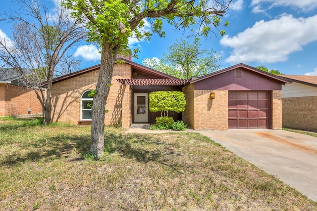 2756 Eunice Dr, San Angelo, TX 76901 - mid-century inspired home featuring an attached garage, brick siding, driveway, and a chimney