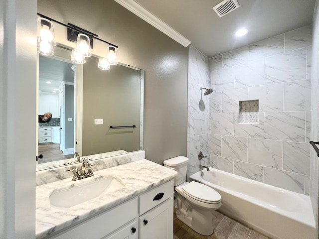 full bathroom with tiled shower / bath, wood-type flooring, vanity, ornamental molding, and toilet