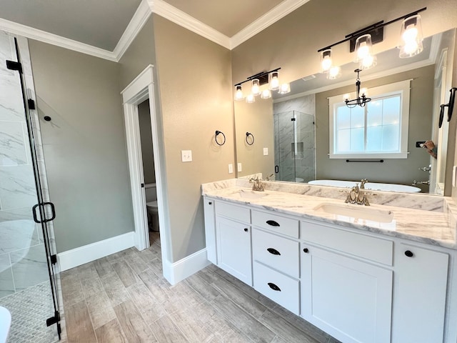 bathroom featuring vanity, a shower with shower door, ornamental molding, and an inviting chandelier