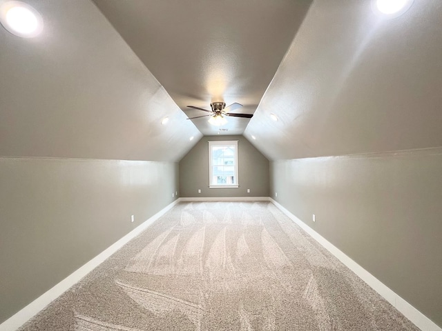 bonus room featuring lofted ceiling, ceiling fan, and carpet flooring