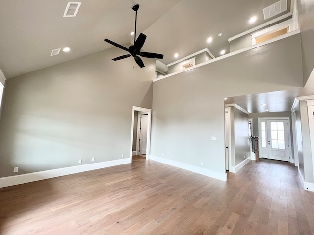 unfurnished living room featuring ceiling fan, high vaulted ceiling, and light hardwood / wood-style flooring