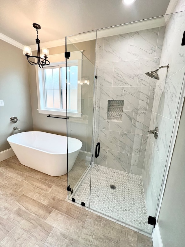 bathroom with crown molding, separate shower and tub, and an inviting chandelier