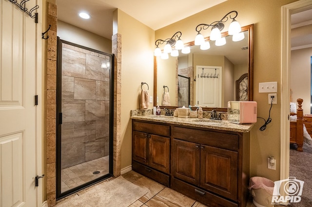 bathroom with vanity and a shower with shower door