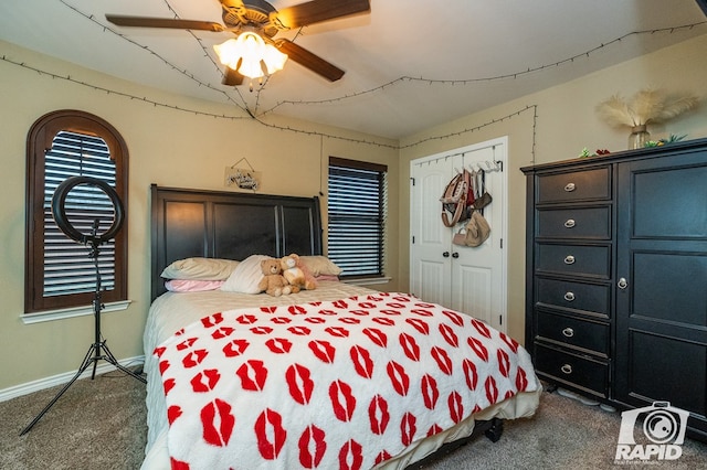 bedroom featuring ceiling fan, a closet, and dark colored carpet