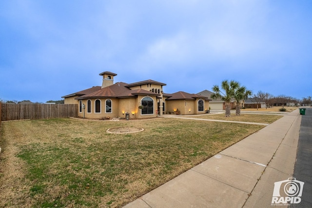 mediterranean / spanish house featuring a front yard