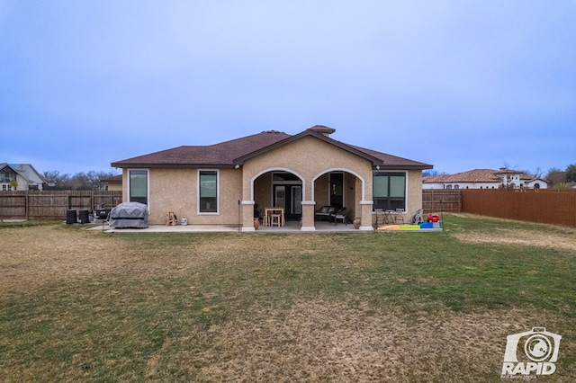 back of property featuring a yard and a patio