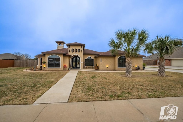 mediterranean / spanish house with a front lawn