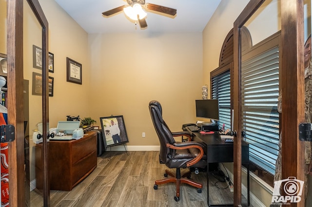 home office featuring hardwood / wood-style flooring and ceiling fan