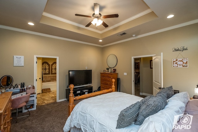 bedroom with ensuite bath, ornamental molding, carpet flooring, and a raised ceiling