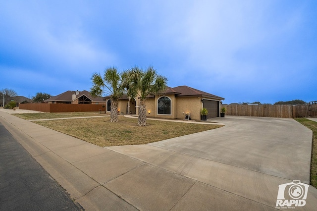 view of front of home featuring a garage and a front yard