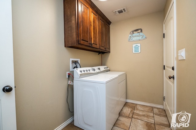 laundry area with independent washer and dryer and cabinets