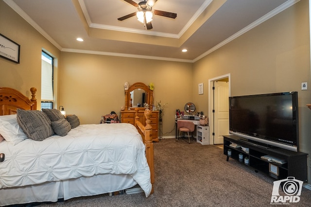 bedroom with ceiling fan, ornamental molding, a tray ceiling, and dark carpet