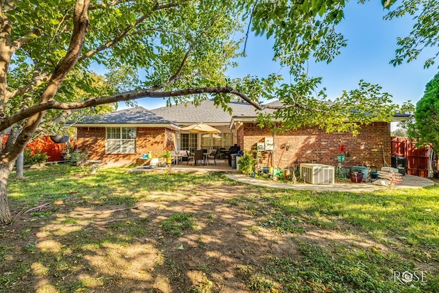 back of property with a patio, cooling unit, fence, and brick siding