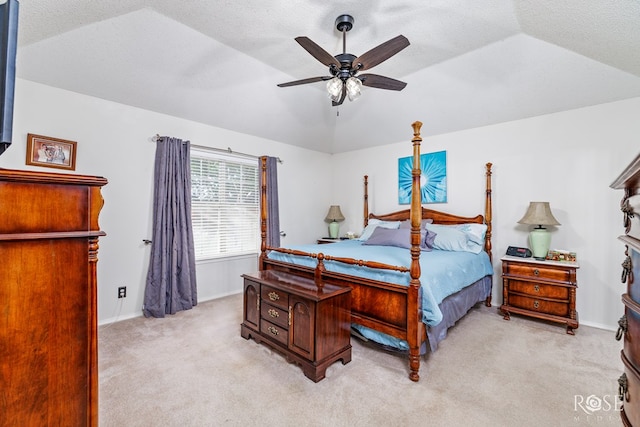 bedroom with light colored carpet, a textured ceiling, a ceiling fan, and lofted ceiling