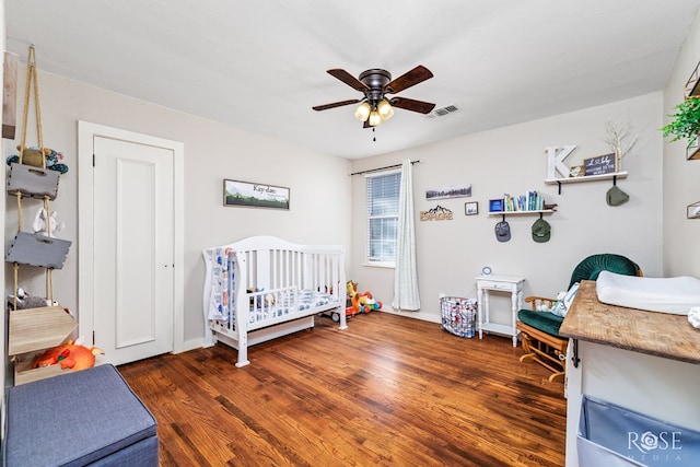 1601 S Jackson St, San Angelo, TX 76903 - bedroom with wood finished floors, a nursery area, and ceiling fan