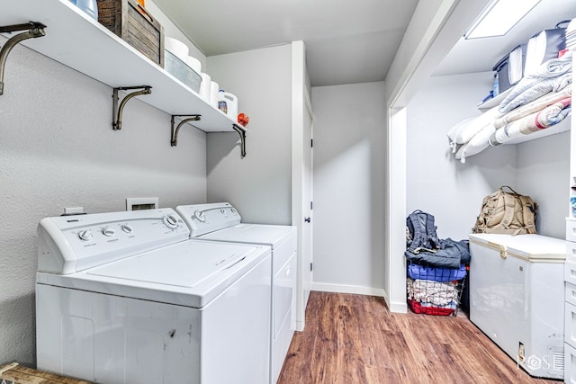 1601 S Jackson St, San Angelo, TX 76903 - laundry area featuring washer and dryer, wood finished floors, and baseboards
