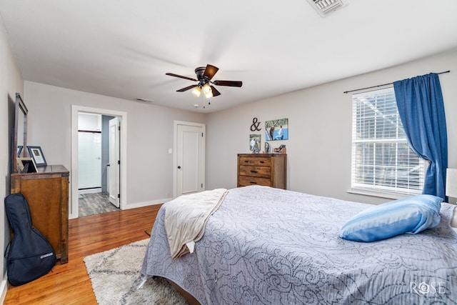 1601 S Jackson St, San Angelo, TX 76903 - bedroom with wood finished floors, baseboards, a ceiling fan, and ensuite bath